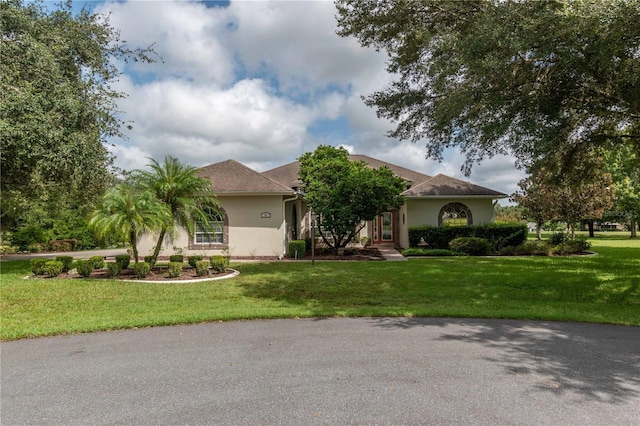 mediterranean / spanish house featuring a front lawn