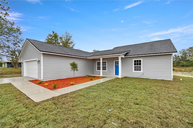 single story home featuring concrete driveway, a front lawn, and an attached garage