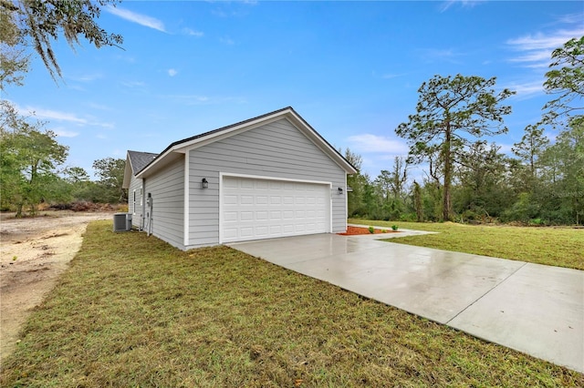 garage featuring central air condition unit and concrete driveway