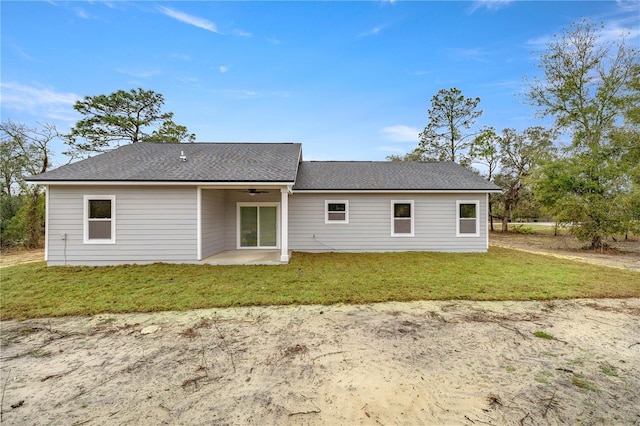 rear view of property featuring a yard and a patio