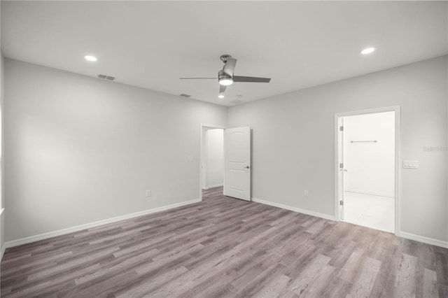 unfurnished room with recessed lighting, visible vents, ceiling fan, light wood-type flooring, and baseboards