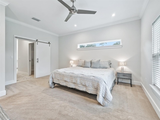 bedroom featuring ornamental molding, ceiling fan, and a barn door