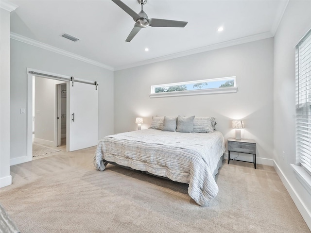 bedroom with light carpet, visible vents, a barn door, and ornamental molding