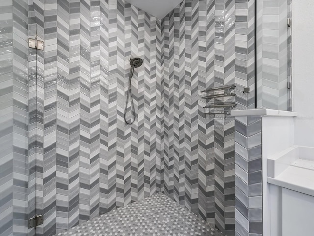 bathroom featuring a shower and vanity