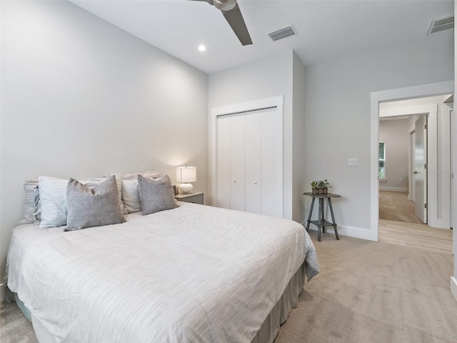 carpeted bedroom with ceiling fan and a closet