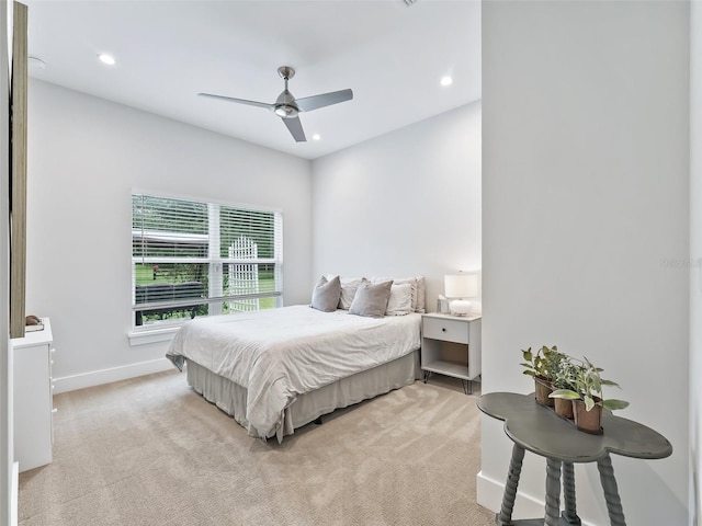 bedroom featuring ceiling fan, recessed lighting, baseboards, and light carpet
