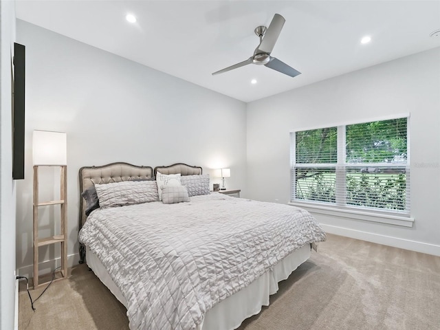 bedroom featuring a ceiling fan, recessed lighting, light colored carpet, and baseboards