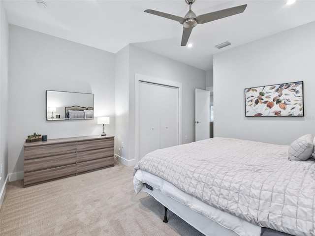 carpeted bedroom with ceiling fan and a closet