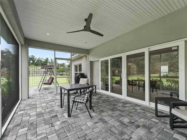 sunroom / solarium featuring ceiling fan