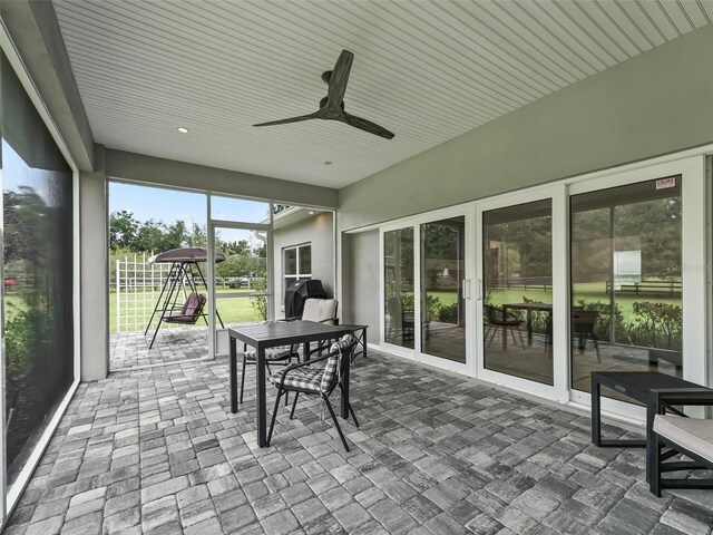 sunroom featuring a ceiling fan