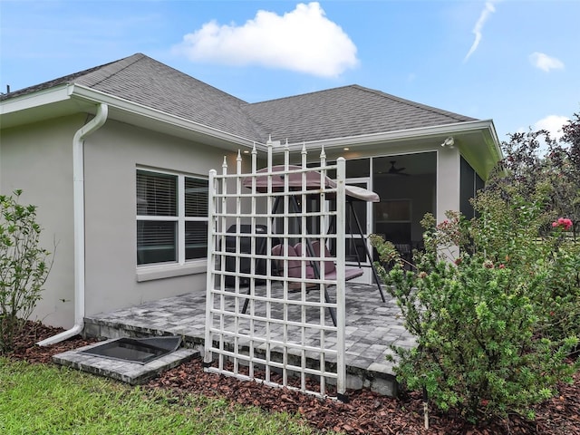 view of home's exterior featuring ceiling fan and a patio