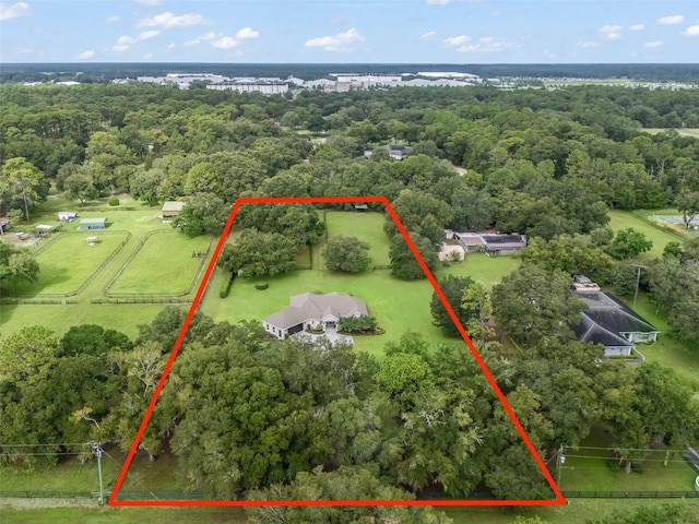 bird's eye view with a wooded view