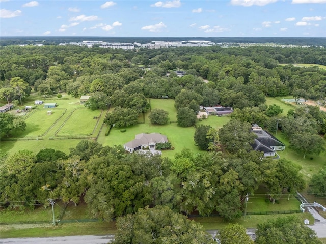 birds eye view of property with a view of trees