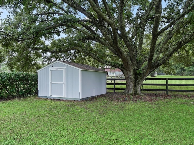 view of shed featuring fence