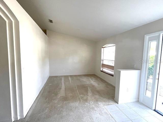 2712 NE 26th St, Ocala, FL 34470 - empty room with light carpet and arched walkways