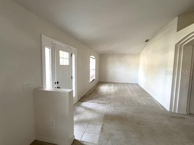 foyer entrance with light carpet