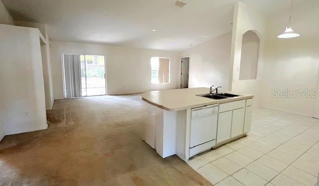 kitchen featuring sink, a center island with sink, dishwasher, white cabinetry, and hanging light fixtures