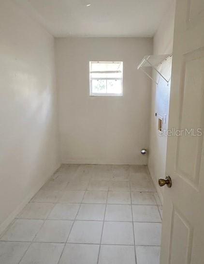 2712 NE 26th St, Ocala, FL 34470 - washroom with hookup for a washing machine, light tile patterned floors, and baseboards
