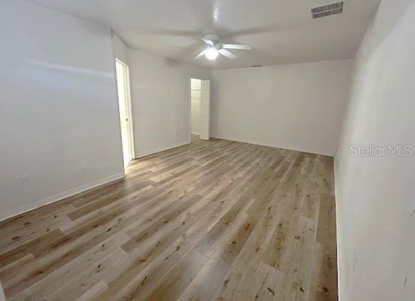 spare room with ceiling fan and light hardwood / wood-style flooring