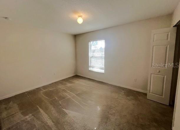 2712 NE 26th St, Ocala, FL 34470 - carpeted empty room featuring baseboards