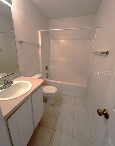 2712 NE 26th St, Ocala, FL 34470 - bathroom with tile patterned floors, toilet, vanity, and bathtub / shower combination