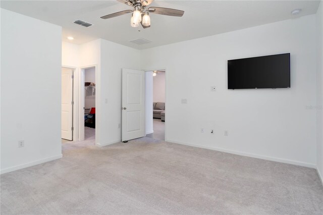 unfurnished room featuring light carpet and ceiling fan