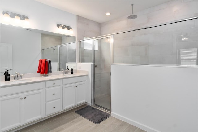 bathroom with vanity and a shower with shower door