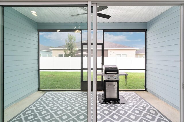 sunroom / solarium featuring ceiling fan and a wealth of natural light