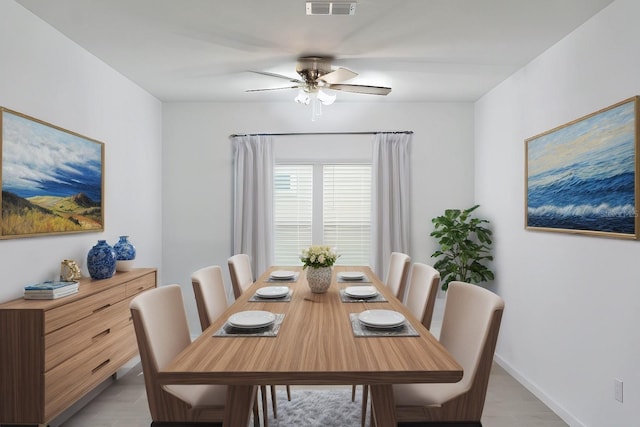 dining space with ceiling fan and light hardwood / wood-style floors