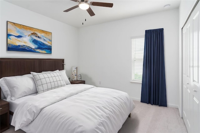 bedroom with light carpet, a closet, and ceiling fan