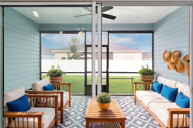 sunroom / solarium featuring ceiling fan