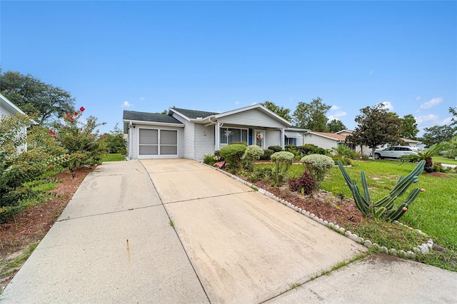 ranch-style home featuring a garage and a front yard