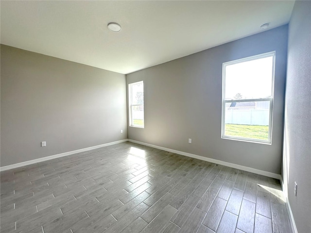 empty room featuring wood finished floors and baseboards