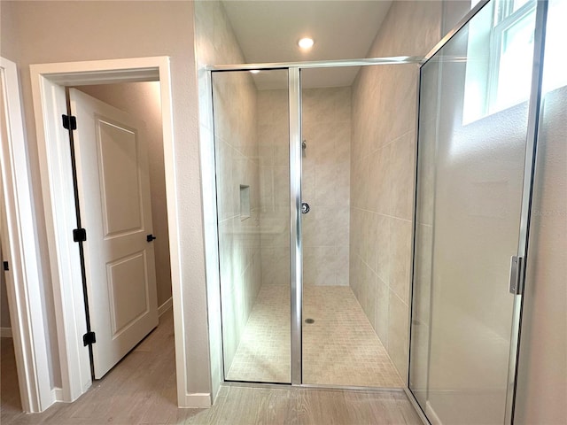 bathroom featuring a stall shower and wood finished floors