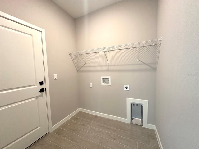 laundry room with washer hookup, wood finish floors, electric dryer hookup, laundry area, and baseboards