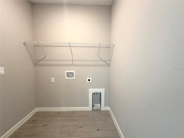 clothes washing area featuring laundry area, wood finish floors, washer hookup, baseboards, and electric dryer hookup