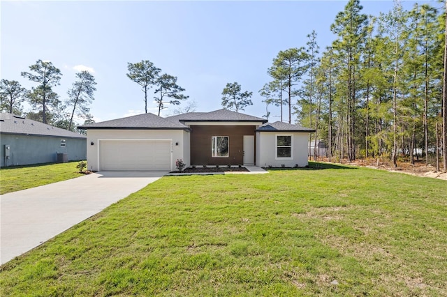 prairie-style house featuring a garage, a front lawn, concrete driveway, and stucco siding