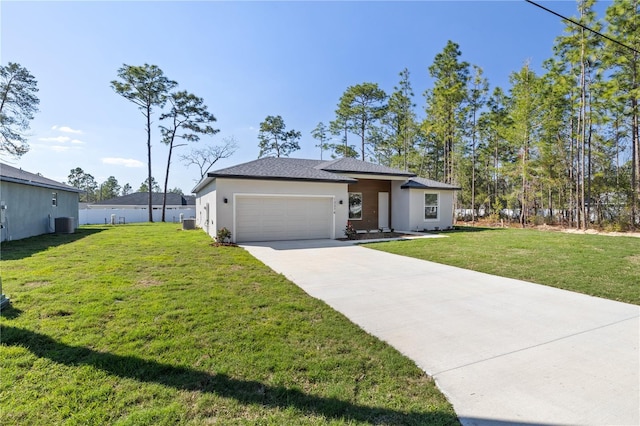 view of front of property featuring a garage, a front lawn, concrete driveway, and stucco siding