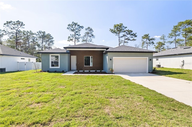 view of front of home featuring a garage, concrete driveway, a front lawn, and stucco siding