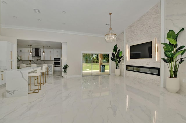 living room with ornamental molding and an inviting chandelier