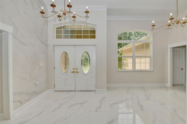 foyer with a high ceiling, ornamental molding, and an inviting chandelier