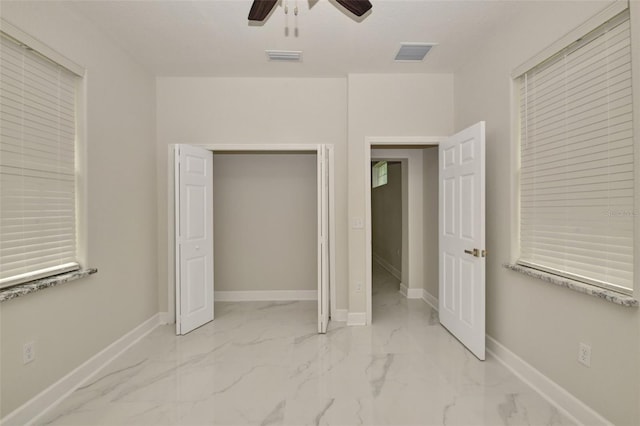 unfurnished bedroom featuring ceiling fan and a closet