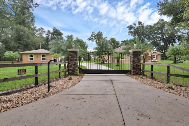 view of gate featuring a yard