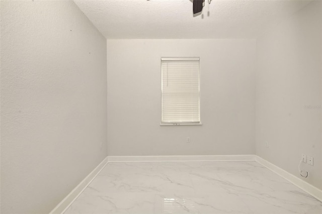 empty room featuring a textured ceiling