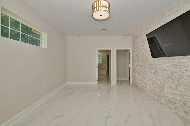 unfurnished room featuring a textured ceiling