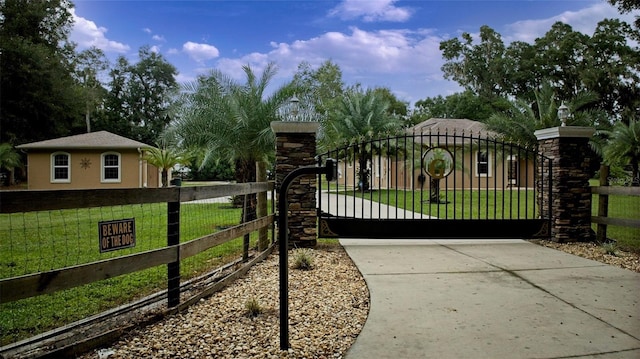 view of gate featuring a yard