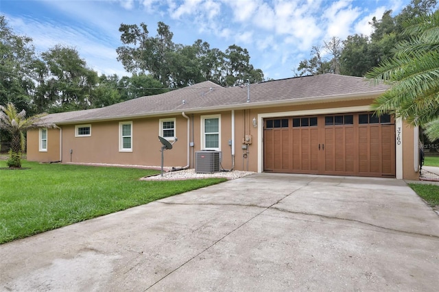 ranch-style house featuring central AC, a front lawn, and a garage