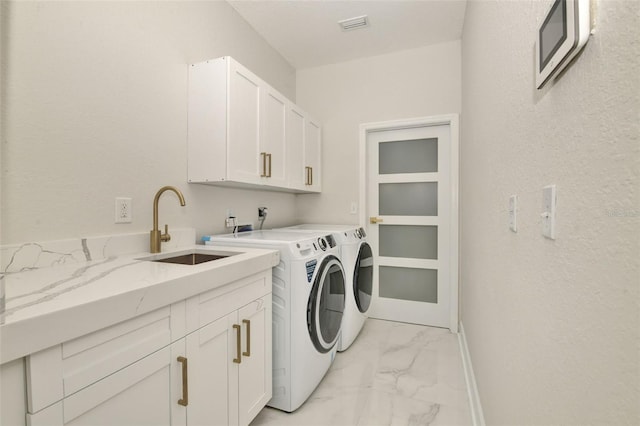 laundry room with cabinets, sink, and independent washer and dryer