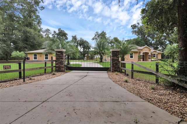 view of gate with a yard