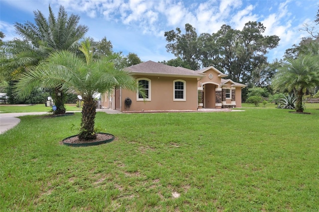 mediterranean / spanish-style house featuring a front yard